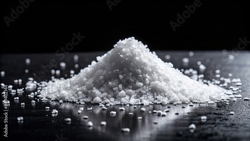 Heap of salt isolated on black background, salt, seasoning, condiment, pile, crystals, cooking, ingredient, texture, sodium photo