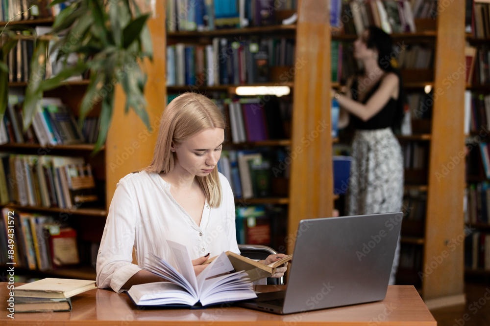 A young teenage girl in the library writes an essay or outline, taking diligent notes. This scene embodies the concepts of passing exams, studying, and education, highlighting her dedication to academ A young teenage girl in the library writes an essay or outline, taking diligent notes. This scene embodies the concepts of passing exams, studying, and education, highlighting her dedication to academ