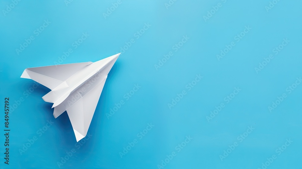 White Paper Airplane on a Blue Background White Paper Airplane on a Blue Background
