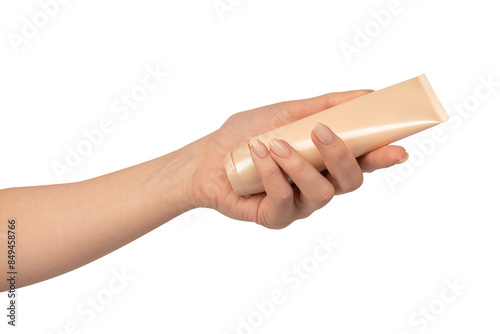 Beige cream tube in woman hands isolated on a white background.