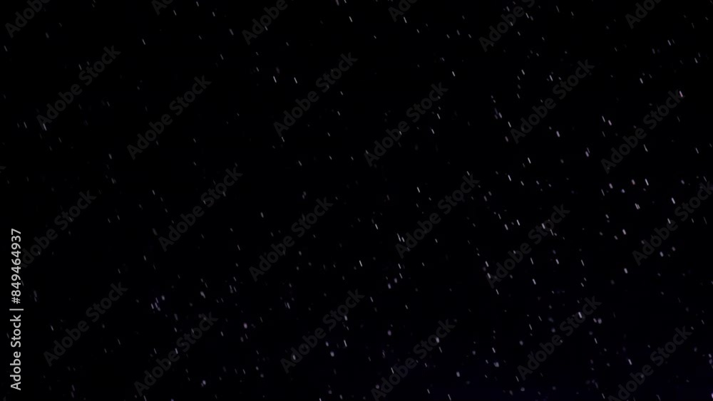Raindrops. Night shower in the spotlight. Slow Motion Raindrops. Night shower in the spotlight. Slow Motion