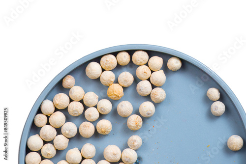 A mound of white peppercorn (white pepper) seeds isolated against a white background.