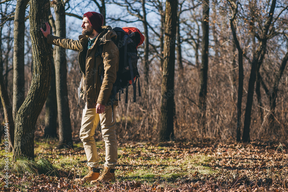 young hipster man traveling with backpack in spring autumn forest young hipster man traveling with backpack in spring autumn forest