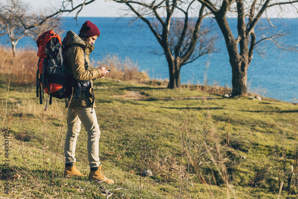 young hipster man traveling with backpack in cold season young hipster man traveling with backpack in cold season