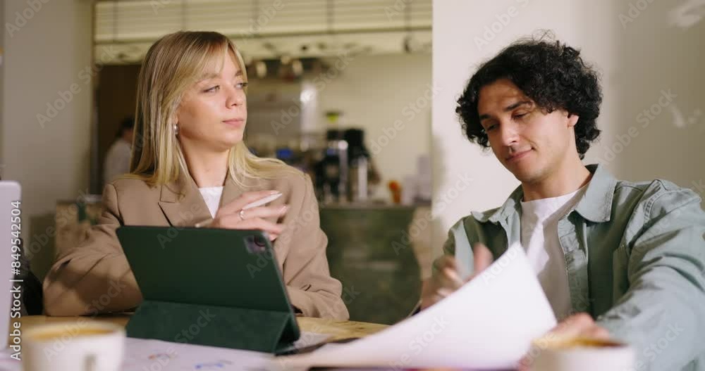 Blonde Woman And Hispanic Man Discussing Working Project In Coworking Area Or Coffee Shop, Medium Portrait Shot, Colleagues Planning Strategy Of Company Development Or Marketing Campaign Blonde Woman And Hispanic Man Discussing Working Project In Coworking Area Or Coffee Shop, Medium Portrait Shot, Colleagues Planning Strategy Of Company Development Or Marketing Campaign