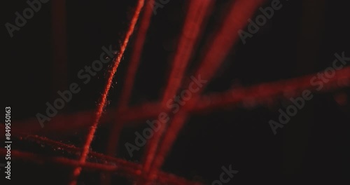 Movement between the taut red threads of the intricacies of the plot