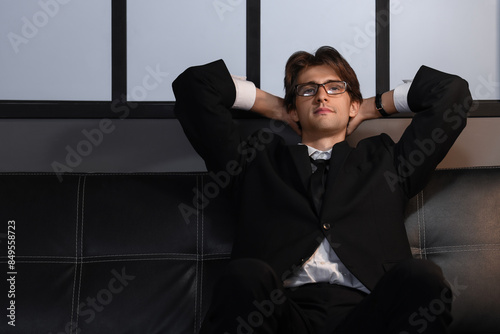 Young businessman sitting o...