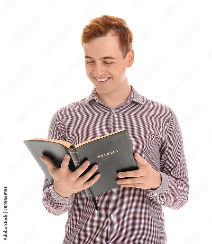 Young redhead man reading Bible on white background Young redhead man reading Bible on white background