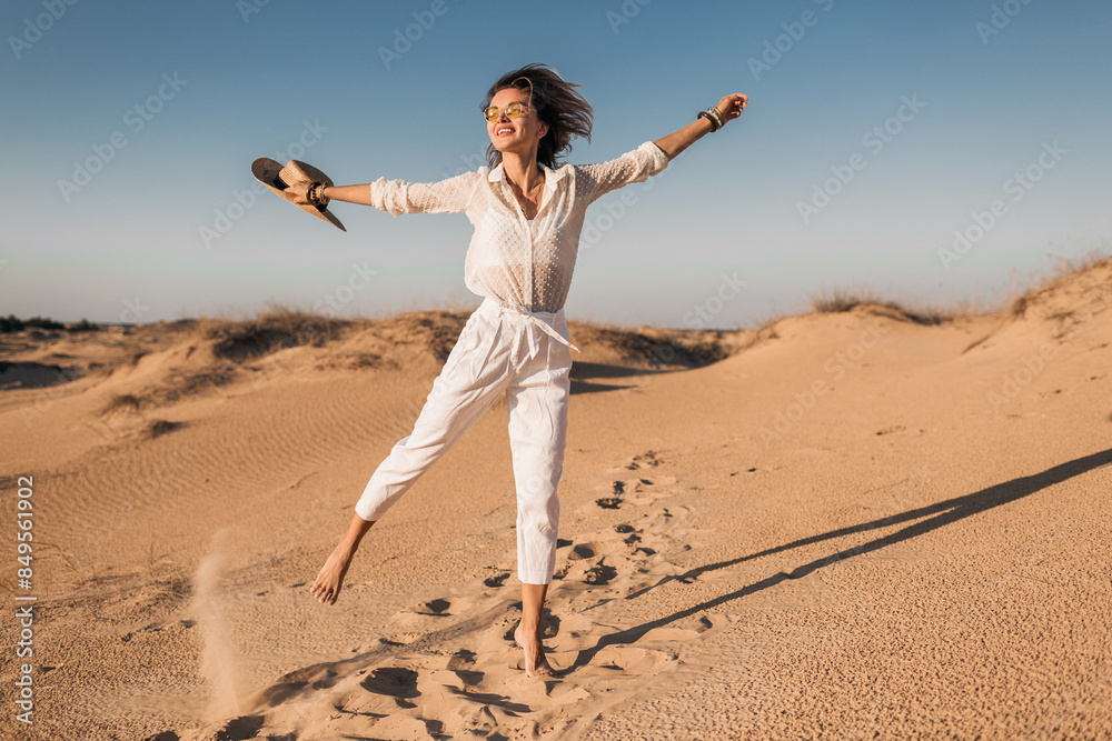 stylish beautiful carefree happy woman walking in desert sand dressed in white outfit stylish beautiful carefree happy woman walking in desert sand dressed in white outfit