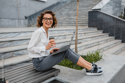 attractive business woman working outside on laptop