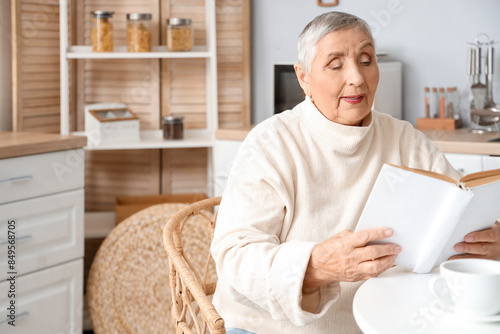 Senior woman reading book a...