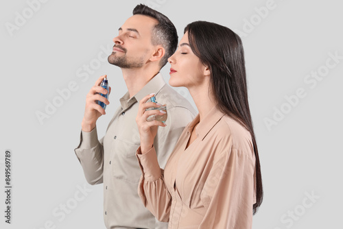 Young couple applying perfu...