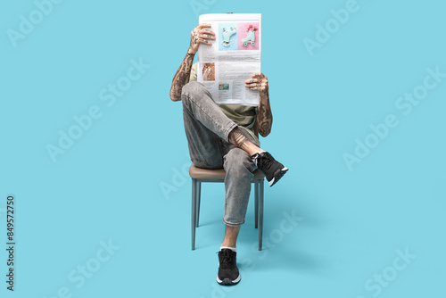 Man with newspaper on blue ...