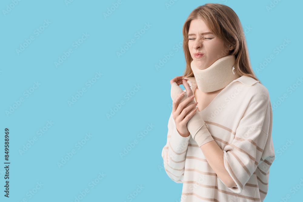 Injured young woman after accident on blue background Injured young woman after accident on blue background