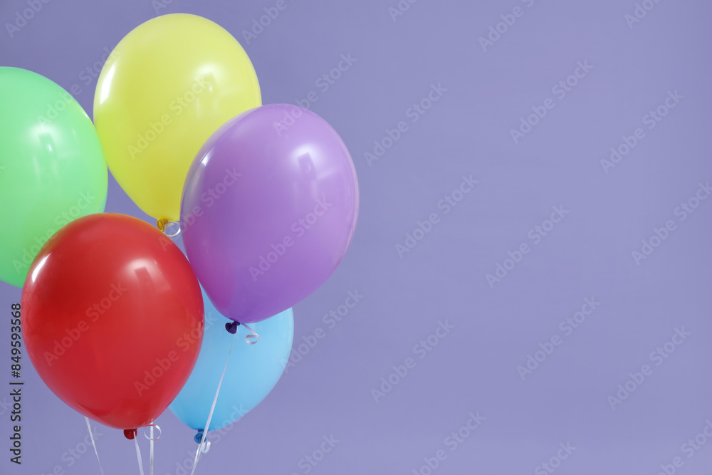 Bunch of colorful floating balloons on lilac background Bunch of colorful floating balloons on lilac background