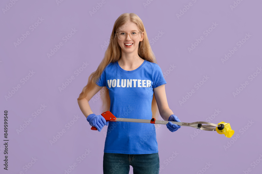 Female volunteer with litter picker tool on lilac background Female volunteer with litter picker tool on lilac background