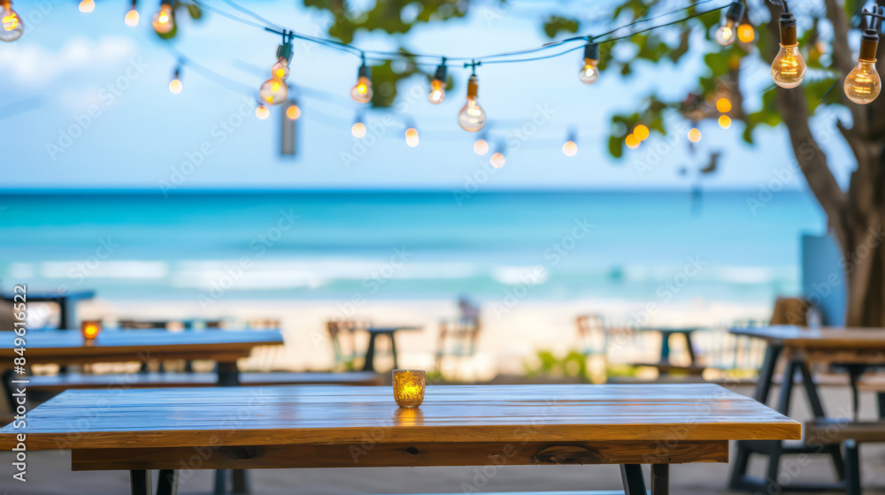 Fototapeta premium Beachside Bar with String Lights and Ocean View at Sunset