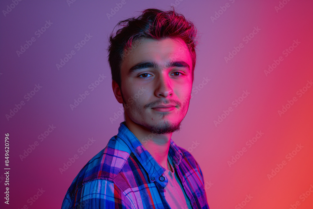 Casual Yet Striking Portrait of a Young Man in a Plaid Shirt, Enhanced by Pink and Purple Neon Lighting Casual Yet Striking Portrait of a Young Man in a Plaid Shirt, Enhanced by Pink and Purple Neon Lighting