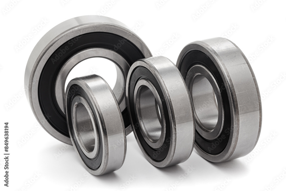 A collection of assorted tapered roller bearings of various sizes, isolated on a white background. A collection of assorted tapered roller bearings of various sizes, isolated on a white background.