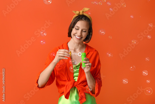 Happy teenage girl blowing ...
