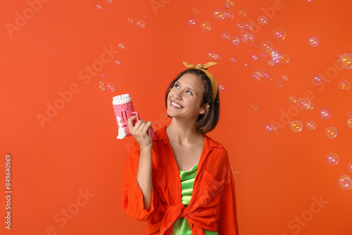 Teenage girl blowing soap b...