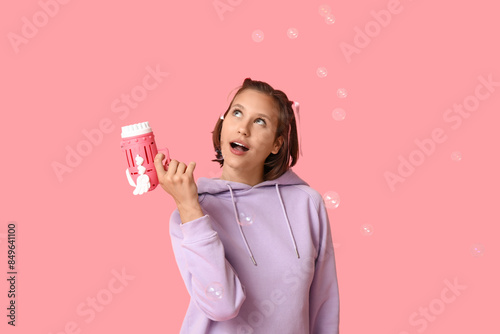 Teenage girl with soap bubb...