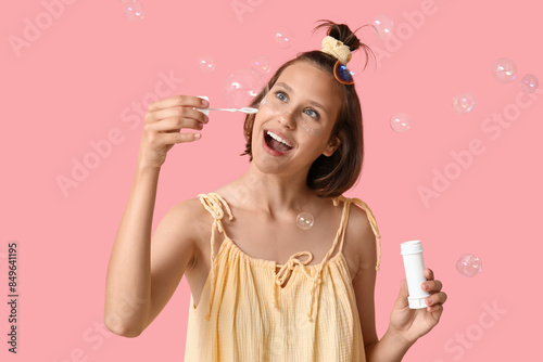 Teenage girl with soap bubb...