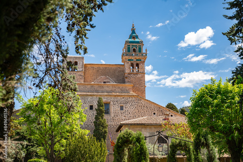 Iglesia de la Cartuja Church Tower, Valldemossa, Majorca, during sunny day with trees in front, horizontal shot, Mallorca