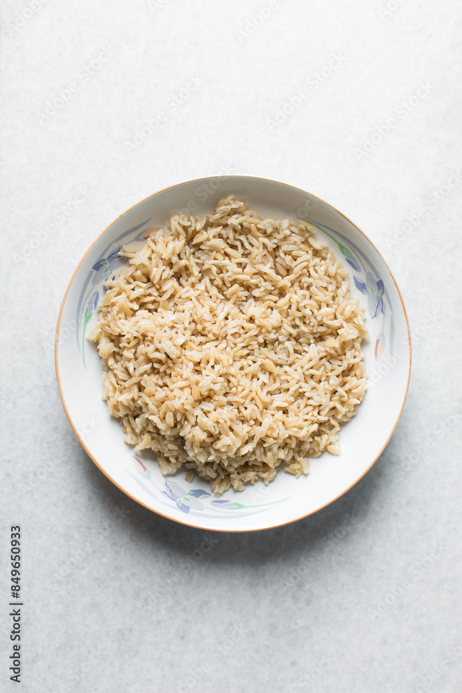 Overhead view of cooked basmati rice in a white ceramic plate, top view of steamed basmati rice in a white bowl Overhead view of cooked basmati rice in a white ceramic plate, top view of steamed basmati rice in a white bowl