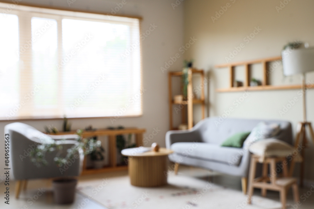 Interior of beautiful living room with grey sofa, shelving unit, coffee table and lamp Interior of beautiful living room with grey sofa, shelving unit, coffee table and lamp