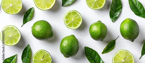 Fresh green limes with leaves on white background
