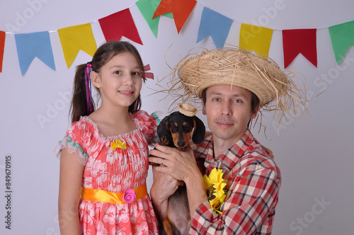 Pai e filha com cachorros , vestidos de caipira  para festa junina, festa julina photo