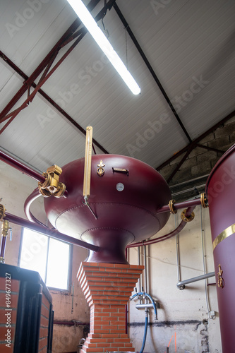 Double distillation process of cognac spirit in Charentias copper alambic still pots and boilers in old distillery in Cognac white wine region, Charente, Segonzac, Grand Champagne, France photo