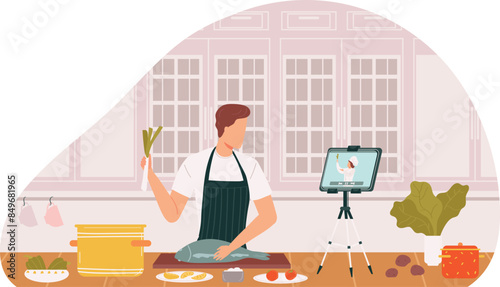 Man cooking while watching recipe video tablet kitchen setup. Male home cook prepares fish learns culinary skills digital tutorial. Casual attire apron using technology kitchen counter ingredients