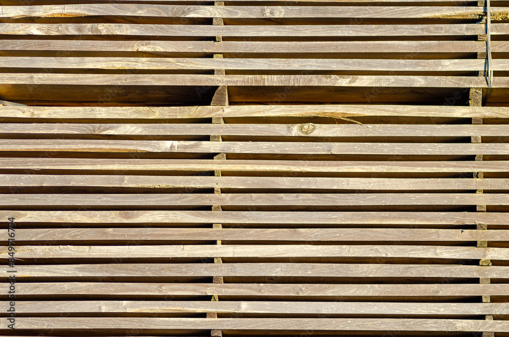 wooden planks stacked in a sawmill, background texture wooden planks stacked in a sawmill, background texture