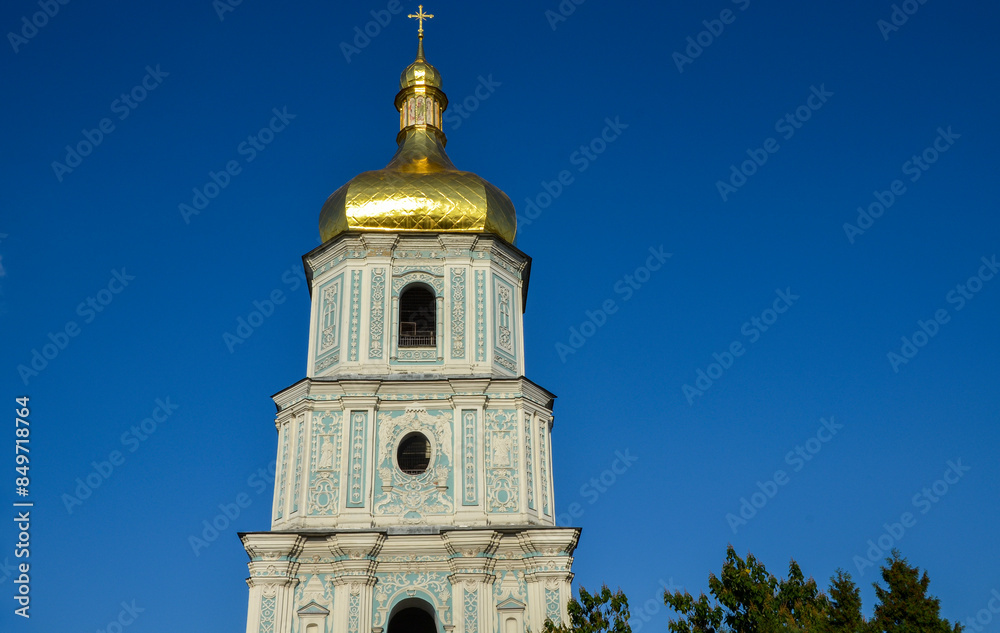 Bell tower of Saint Sophia Cathedral stands tall against a clear blue sky, features intricate architectural details, including golden dome and ornate designs. Kyiv, Ukraine Bell tower of Saint Sophia Cathedral stands tall against a clear blue sky, features intricate architectural details, including golden dome and ornate designs. Kyiv, Ukraine