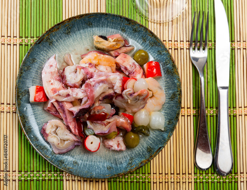 Salad of Spanish cuisine is Seafood Salpicon, made from chopped seafood and vegetables in a dressing or sauce photo