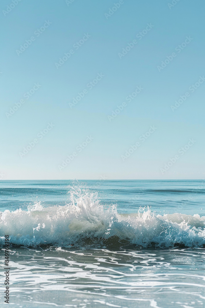 Fototapeta premium A solitary wave in a calm sea under a clear sky.