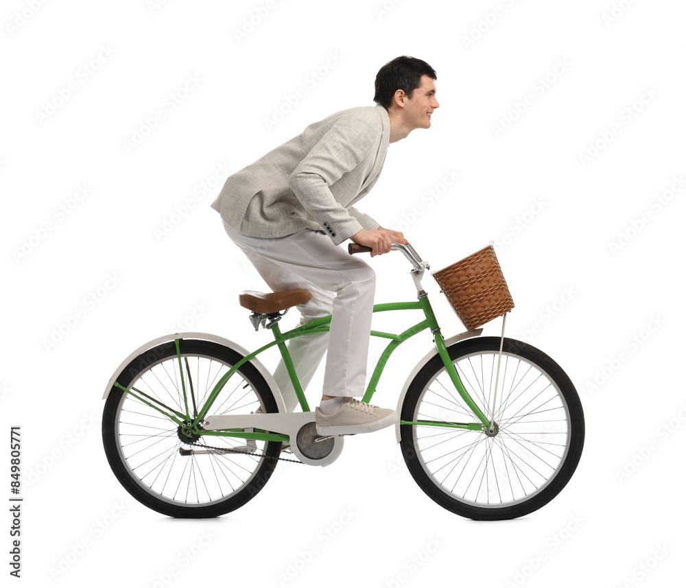 Obraz premium Smiling man riding bicycle with basket on white background