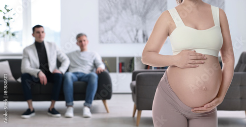 Konstfotografi Pregnant surrogate mother and happy gay couple at home, selective focus