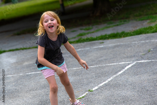 little girl jumped up and down in excitement after successfully passing the pink ball over the net.