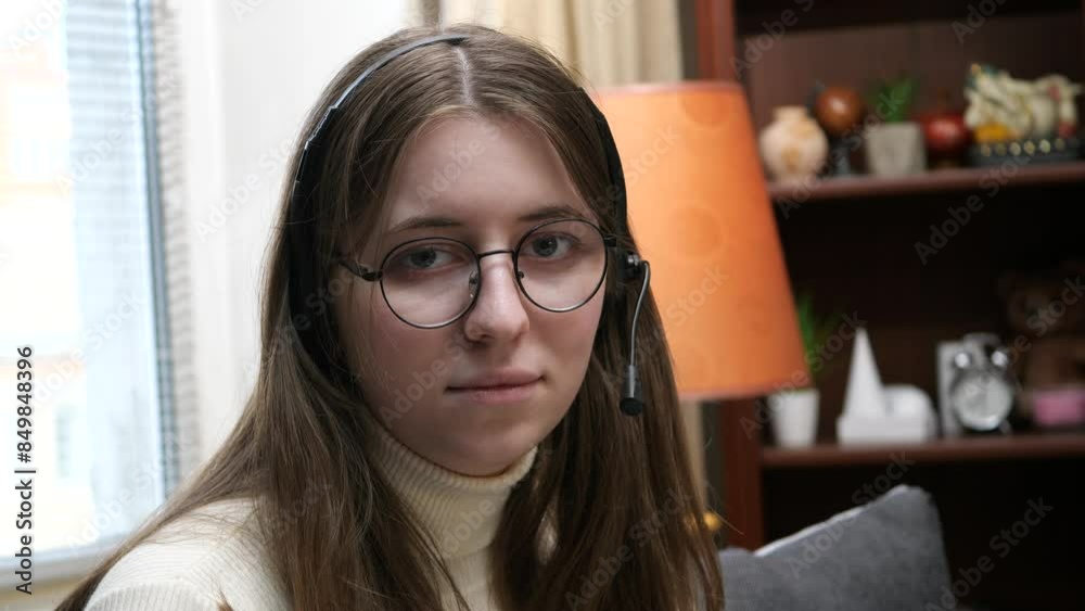 A young beautiful girl, in a white blouse with glasses, turns her head and looks intently. Slow motion. A young beautiful girl, in a white blouse with glasses, turns her head and looks intently. Slow motion.