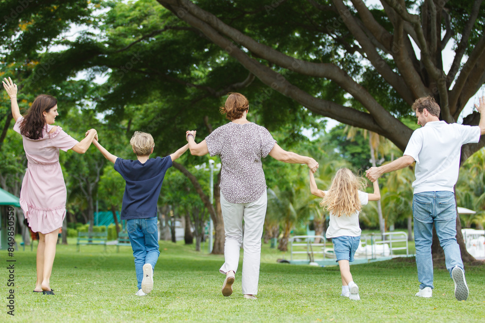 Caucasian family parent and their children picnic at the park in morning. Caucasian family parent and their children picnic at the park in morning.