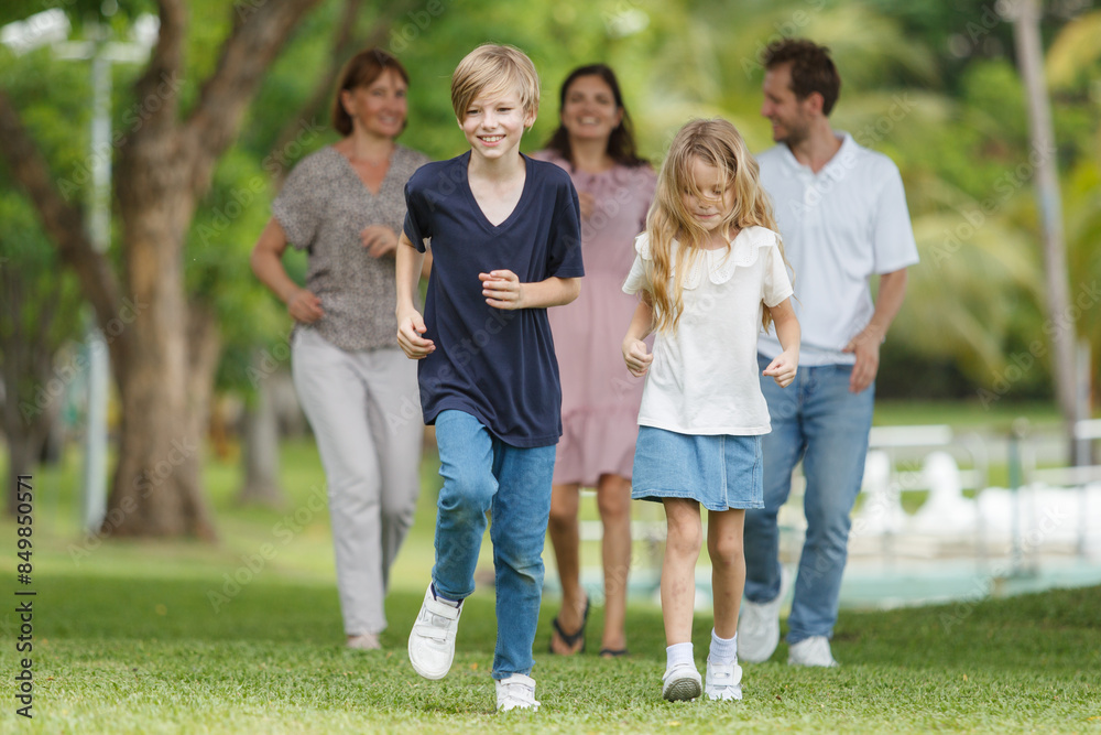 Caucasian family parent and their children picnic at the park in morning. Caucasian family parent and their children picnic at the park in morning.