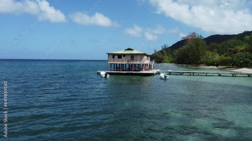 boat and house on the sea in Islas de la Bahia Honduras boat and house on the sea in Islas de la Bahia Honduras
