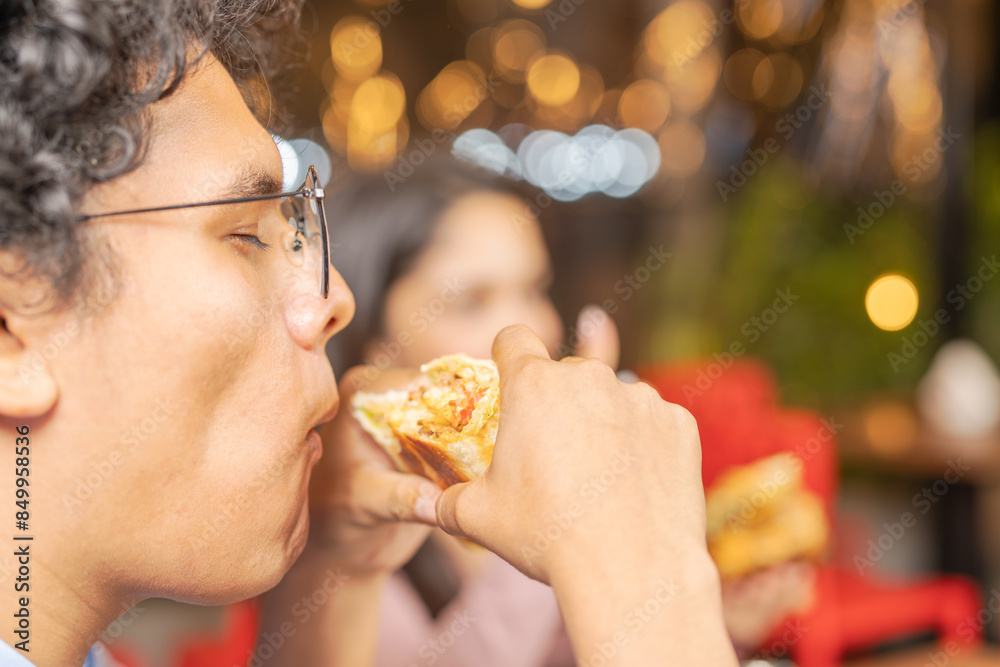 A man enjoying his burrito in the restaurant A man enjoying his burrito in the restaurant