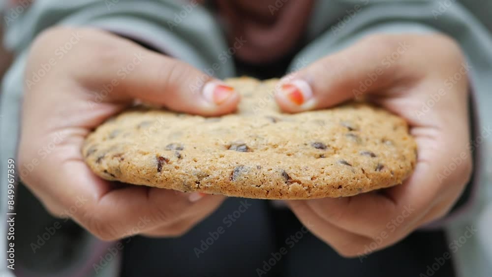 top view of hand breaking sweet cookies 