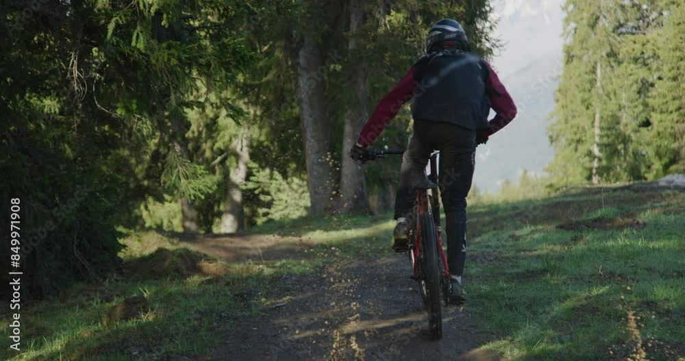 Professional biker riding through puddle on forest trail - slow motion Professional biker riding through puddle on forest trail - slow motion