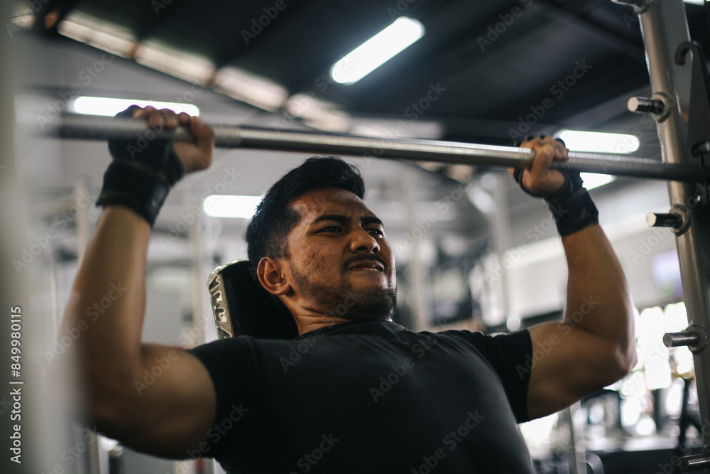 Young Asian Muscular Man Working Out In Gym Doing Exercises With Barbell At Biceps. Young Asian Muscular Man Working Out In Gym Doing Exercises With Barbell At Biceps.
