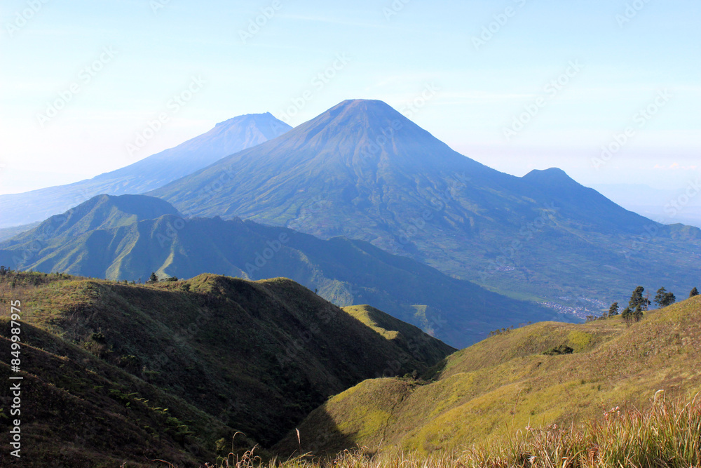 stunning view from the summit of Mount Prau with clear sky, Dieng, Central Java. Looking from left to right Mount Sumbing, Mount Sindoro, and Mount Kembang. stunning view from the summit of Mount Prau with clear sky, Dieng, Central Java. Looking from left to right Mount Sumbing, Mount Sindoro, and Mount Kembang.